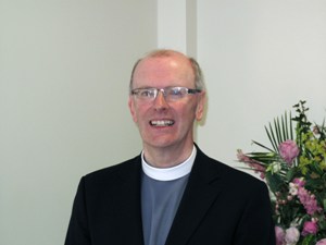 Rev. Dr. David Murphy smiling in clerical collar