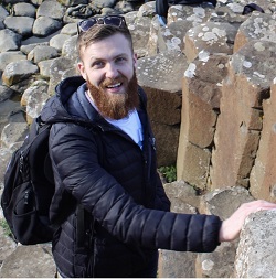 Stuart McKimm pictured outdoors beside stone columns